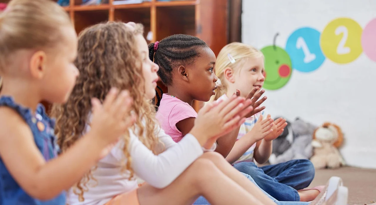 Learning made fun. Shot of children clapping hands while sitting in class